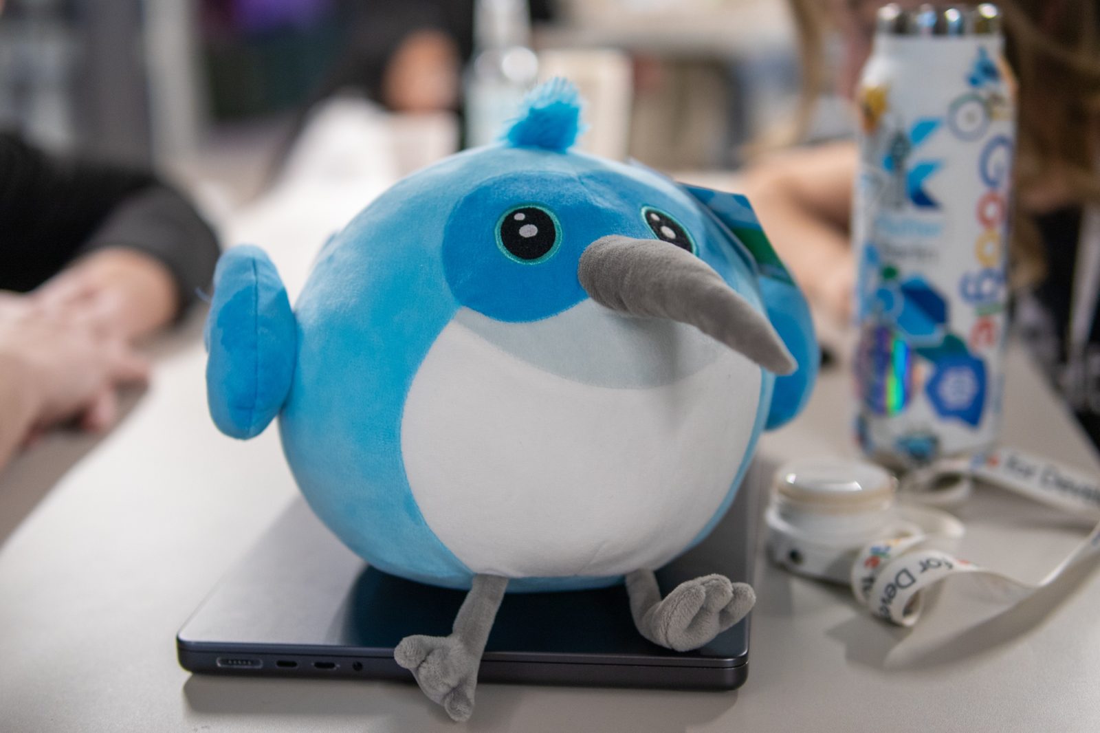 Dash plush mascot on a laptop