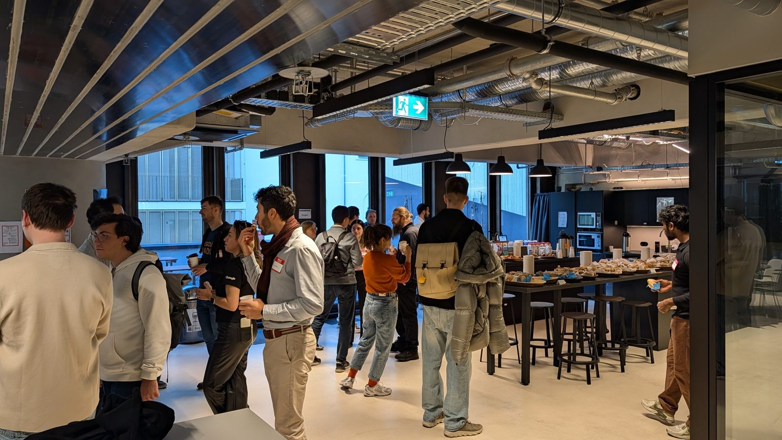 Attendees networking over coffee and pastries